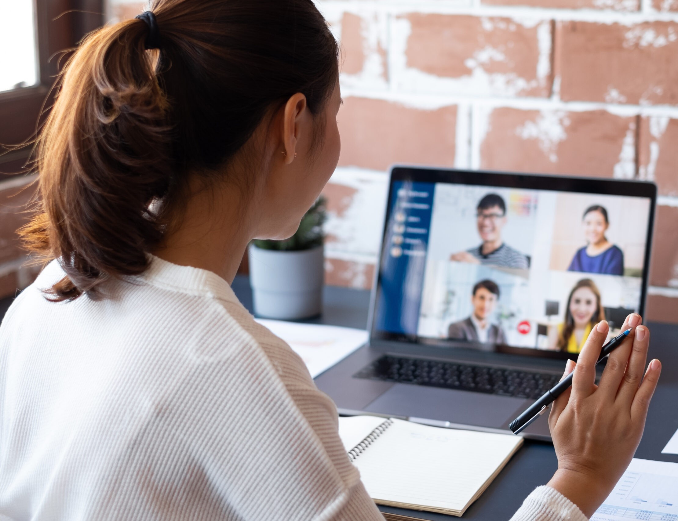 Young Asian businesswoman work at home and virtual video conference meeting with colleagues business people, online working, video call due to social distancing at home office Young Asian businesswoman work at home and virtual video conference meeting with colleagues business people, online working, video call due to social distancing at home office